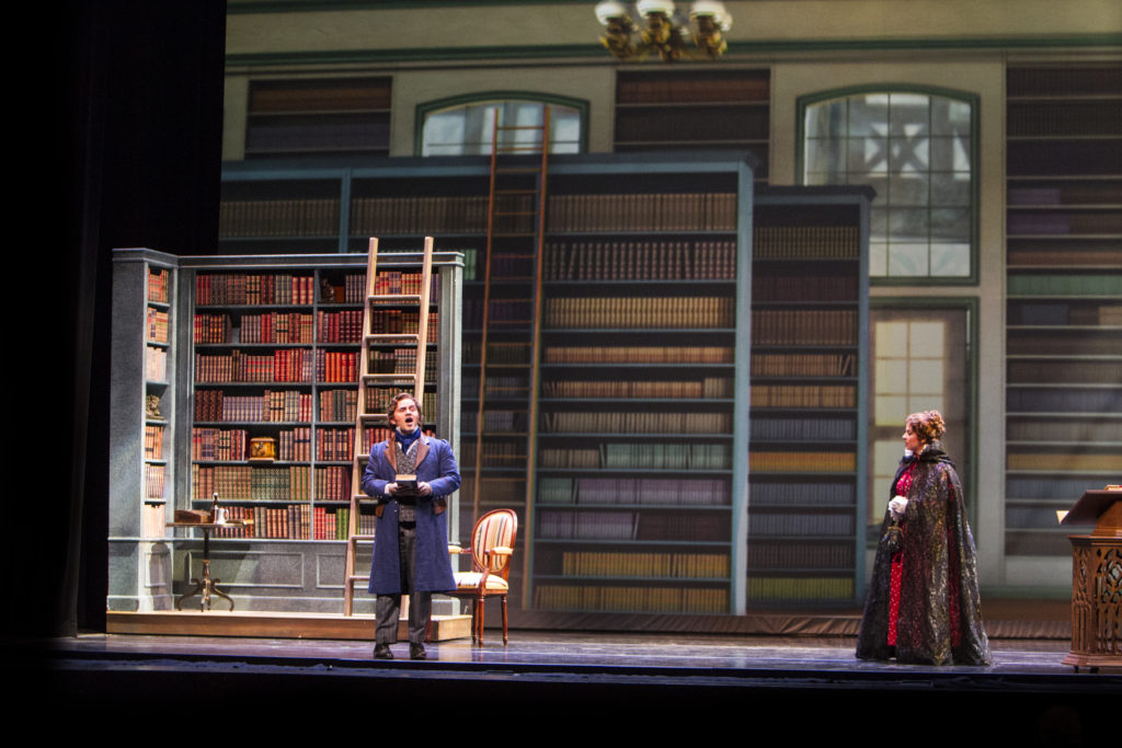 Tenor Andrew Owens as earnest and ambitious Bavarian book dealer Franz Bierman, in his shop on St. Martin Platz, where he and Anna bond over their shared loneliness and love of books. 